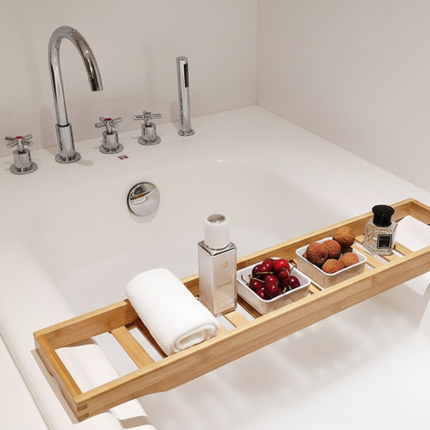 Bath tray with wine, fruits on a bathtub. Wooden tray on a white background on a white bathtub. Earthy wooden home decor inspired by natural textures and warm tones. Earthy wooden home decor inspired by natural textures and warm tones. Calm and cozy bathroom decor.