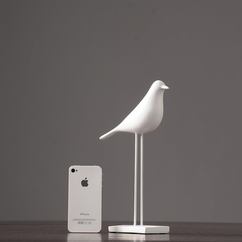 One white Nordic bird decoration made from resin, designed in a nordic and minimalist style, placed on a grey background.