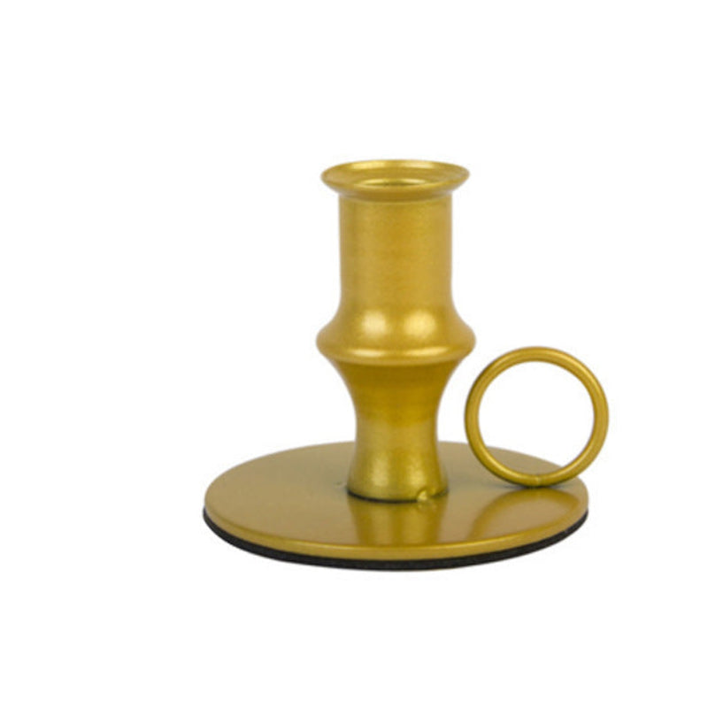 Gold candle holder on a white background. Golden retro candle holder on a white background. Elegant iron gold. Minimalistic home decor.