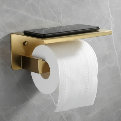 Gold toilet paper holder with a roll of toilet paper and a smartphone on a gray marble wall. Stylish golden bathroom rack. Modern bathroom rack, minimalist and timeless pieces for bathroom.