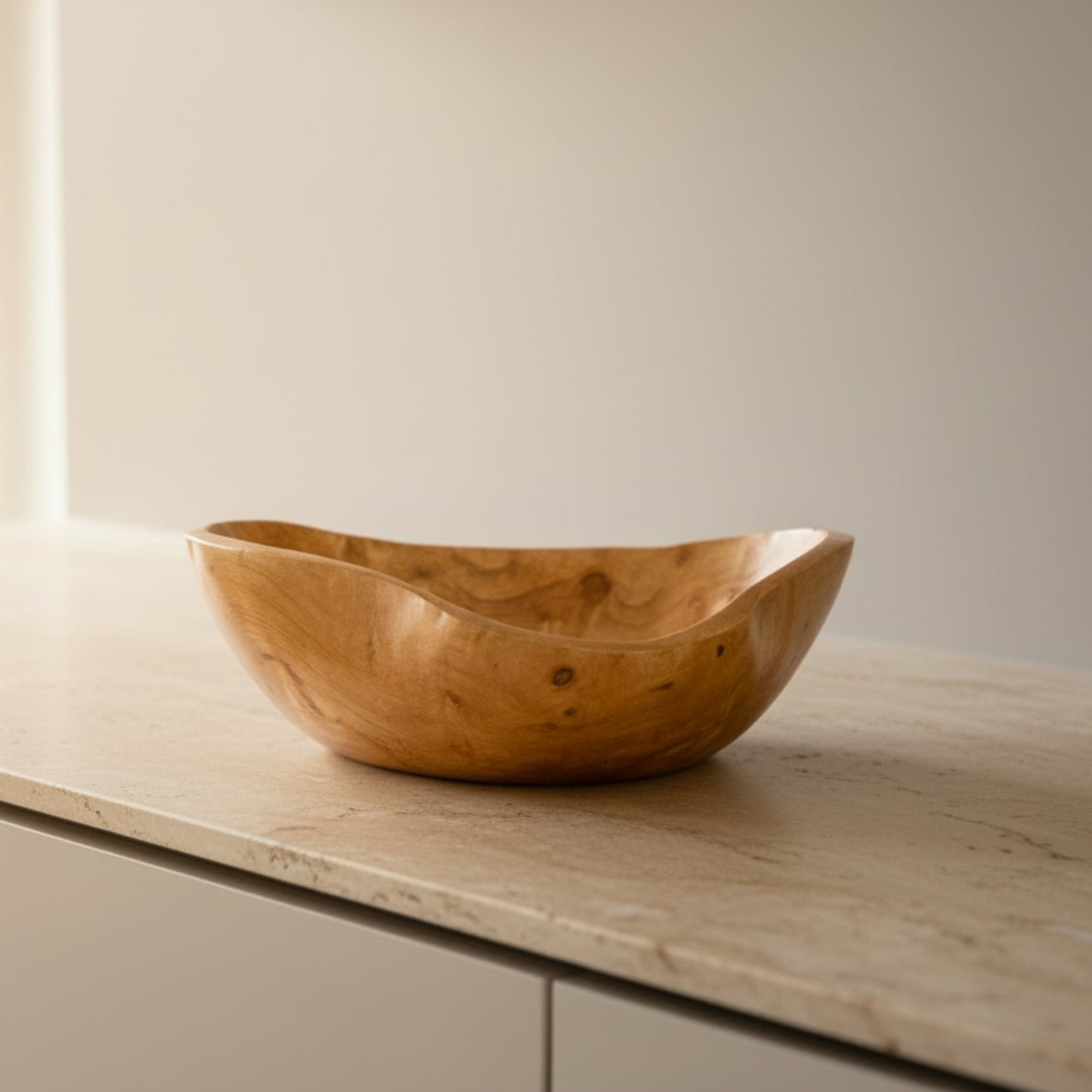 Wooden bowl on a light-brown kitchen marble surface with a beige background. Scandinavian earthy natural decor styling. 