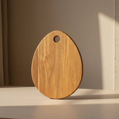 Wooden cutting board with a handle on a beige background and beige surface. Minimalist and natural Scandinavian style. 