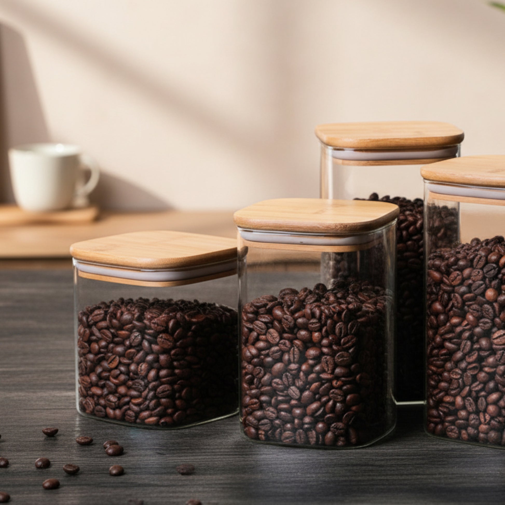 Set of glass jars with wooden lids filled with coffee beans on a black colored wooden kitchen surface. Different sizes of airtight jars. a warm minimalist interior with natural decor and simple design. Storage kitchen jar. 