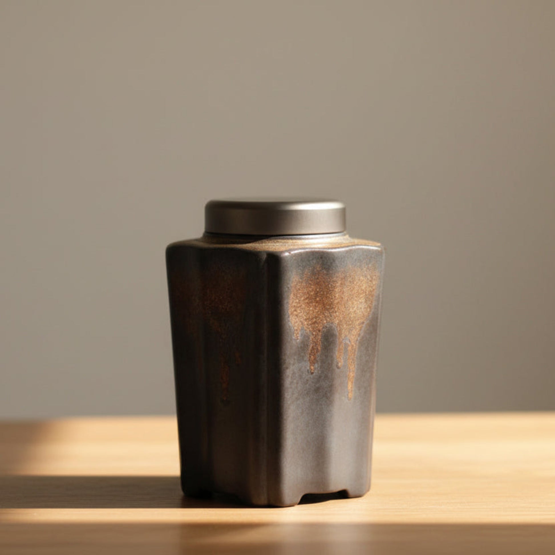 Antique and handcrafted tea caddy on a wooden surface on a beige background. Stylish kitchen decor. Modern accessories, natural materials, and timeless pieces. 