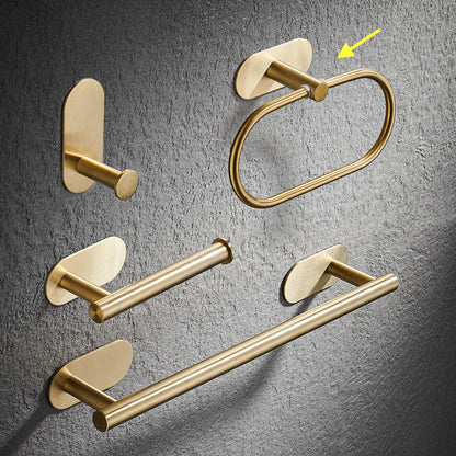 Set of gold bathroom rack including a hook, towel ring, and towel bar on a gray textured background. Stylish golden bathroom rack. Modern bathroom rack, minimalist and timeless pieces for bathroom. 