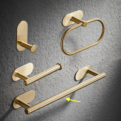 Set of gold bathroom rack including a hook, towel ring, and towel bar on a gray textured background. Stylish golden bathroom rack. Modern bathroom rack, minimalist and timeless pieces for bathroom. 