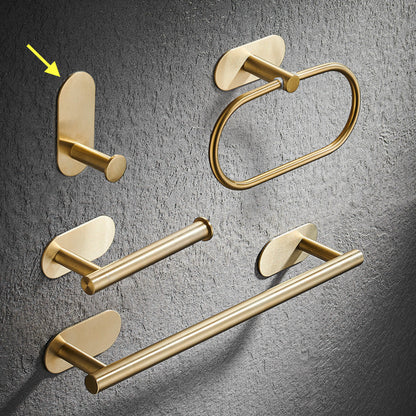 Set of gold bathroom rack including a hook, towel ring, and towel bar on a gray textured background. Stylish golden bathroom rack. Modern bathroom rack, minimalist and timeless pieces for bathroom. 
