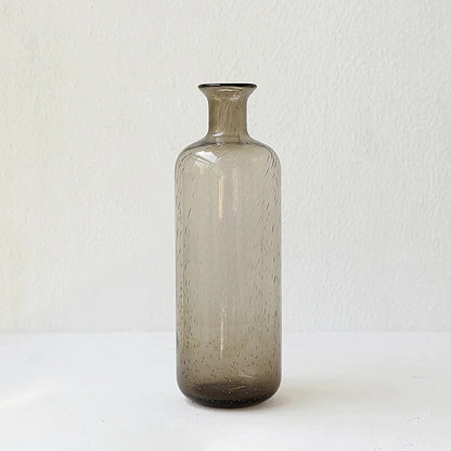 A collection of bubble glass vases in various sizes, with a geometric shape and a translucent stained glass appearance on a white surface and on a white background. 