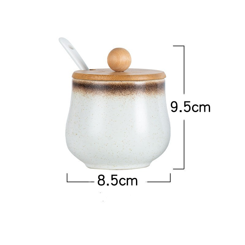 A white ceramic jar with Japanese style designs, featuring with a speckled brown pattern on a white background and with measurements. The jar comes with wooden lids and a spoon. 