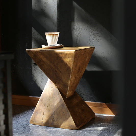 Minimalist wooden side table on a black wall background.  Modern decor piece. Clean lines, natural materials, and timeless piece. 