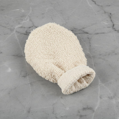 Beige scrubbing glove on a grey marble surface.  Natural home decor designed with warm earthy tones and organic materials.   