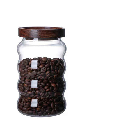 One large glass jar with wooden lid, filled with coffee beans and on a white background. Scandinavian kitchen decor inspired. Simplicity, natural materials, earthy, warm, pure. 