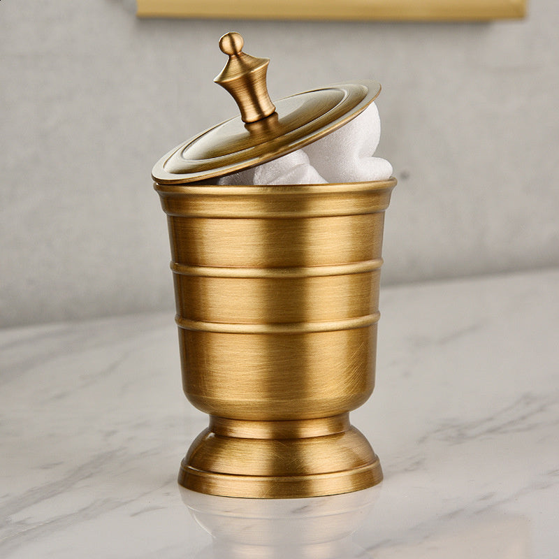 A set of gold-colored copper bathroom accessories including a toothbrush holder, soap dispenser, tumbler, and a tray, displayed on a white surface.
Stylish golden bathroom decor designed to elevate every bathroom space. Soap dispenser on white background. 