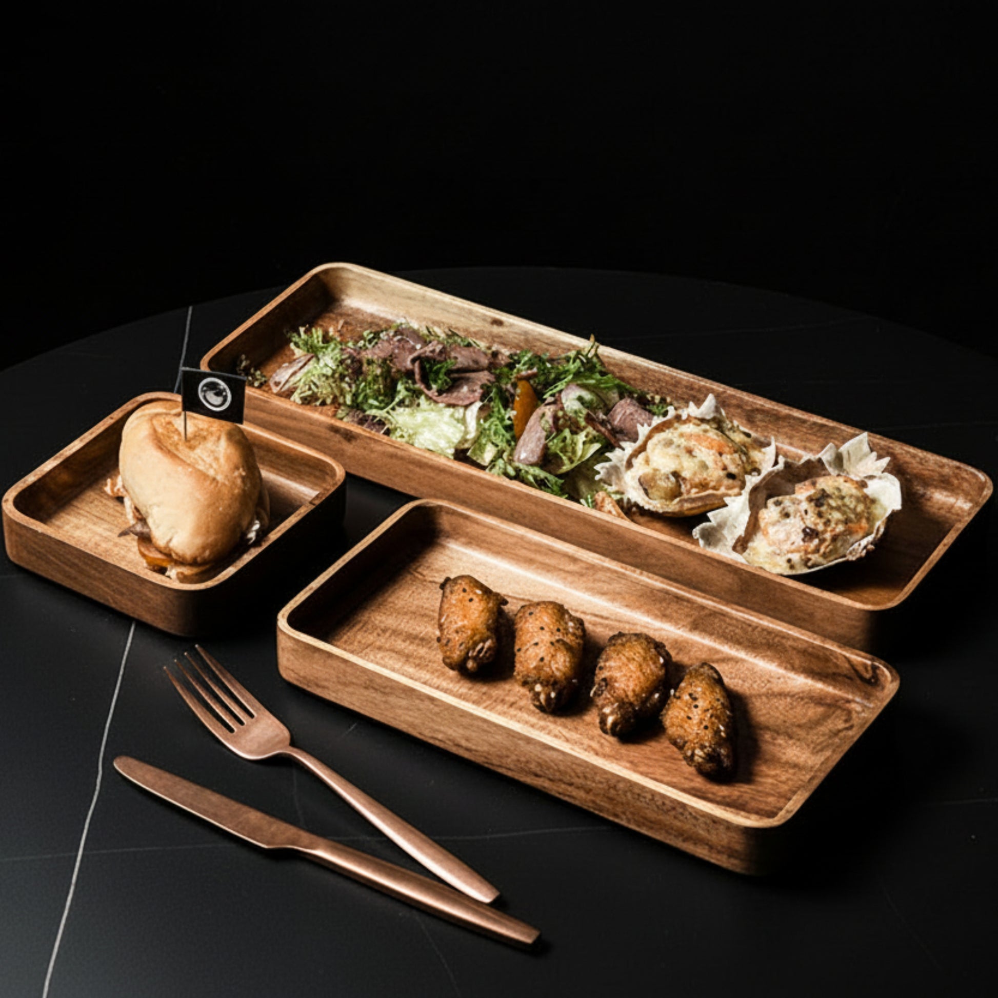 Three wooden platter with food on a dark kitchen surface. Hand-painted and eco-friendly. Japanese minimalist and natural style. 