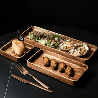 Three wooden platter with food on a dark kitchen surface. Hand-painted and eco-friendly. Japanese minimalist and natural style. 