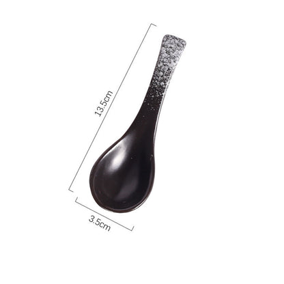 A handcrafted ceramic spoons with a speckled pattern in shades of black, grey and white on a white background and measurements. Handcrafted ceramic spoon in different colors. 