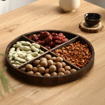 Wooden tray with compartments filled with various nuts and dried fruits on a wooden surface. Wooden tray on a table. Natural decor styling ideas for calm and modern kitchen items. Minimalist pieces designed to bring warmth and harmony to every living space.