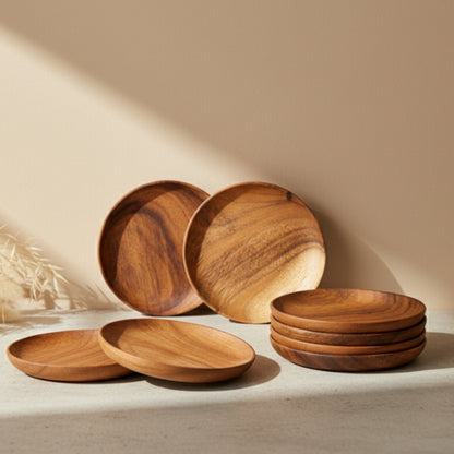 Wooden tableware set on a bright kitchen surface against a beige wall background. Walnut tableware with natural grain and minimalist design. 
