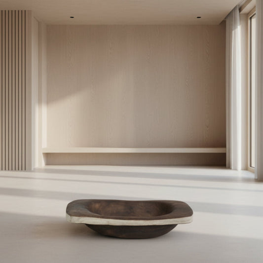 Wooden bowl on a light wooden floor with a neutral wall and window in the background. Beige background with a centerpiece wooden tray in the front. 