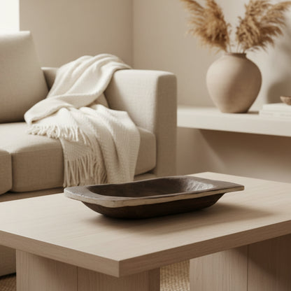 Wooden tray with warm earthy tones on a wooden table on a beige background. Organic materials. Perfect for creating a calm and minimalist interior atmosphere. Tray for every room. Dried flowers in the background. 