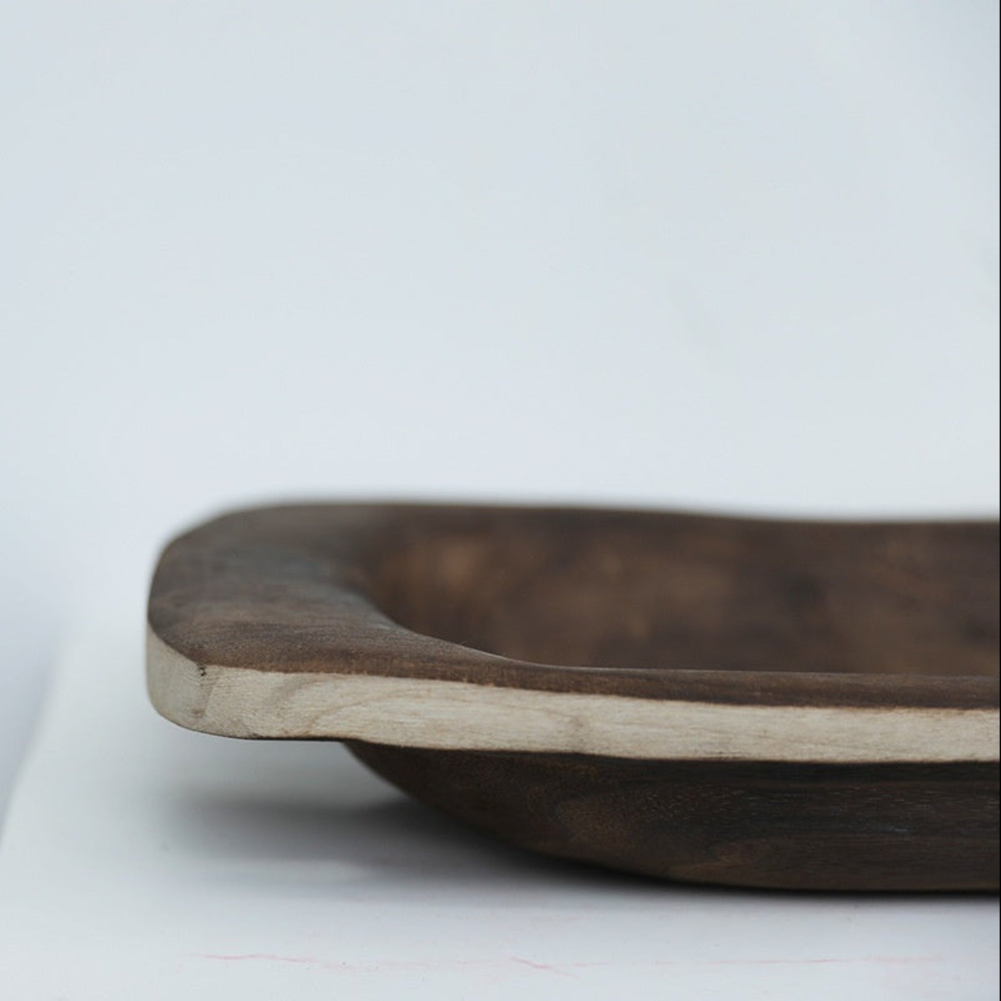 white  background with a centerpiece wooden tray (close up) in the front. Natural home decor designed with warm earthy tones and organic materials. 