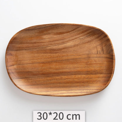 A set of acacia wooden trays with an irregular shape, displayed in various sizes on a white kitchen surface. Natural decor. Minimalist decor piece with warmth and harmony. 