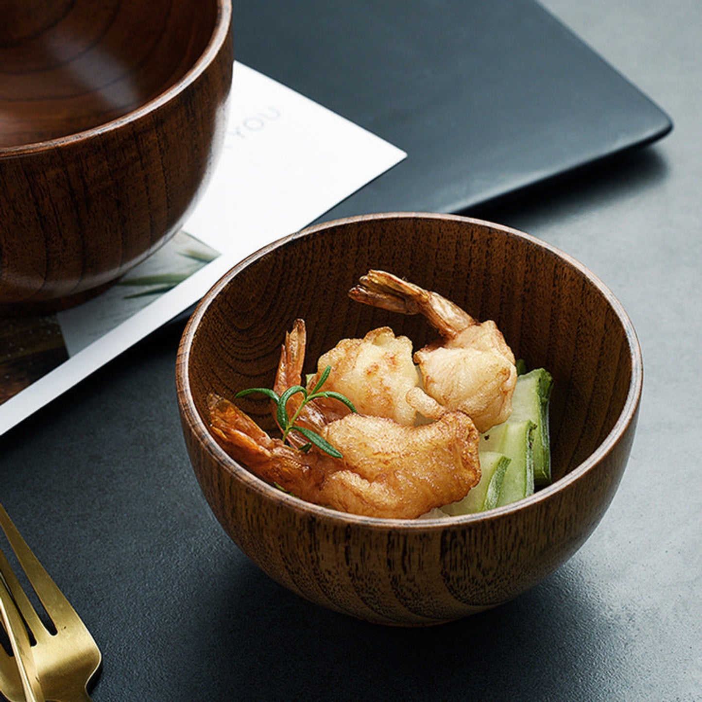 Wooden bowl with fried prawns and vegetables on a dark surface. Solid wood. Japanese style. Earthy, warm and natural ambience. 
