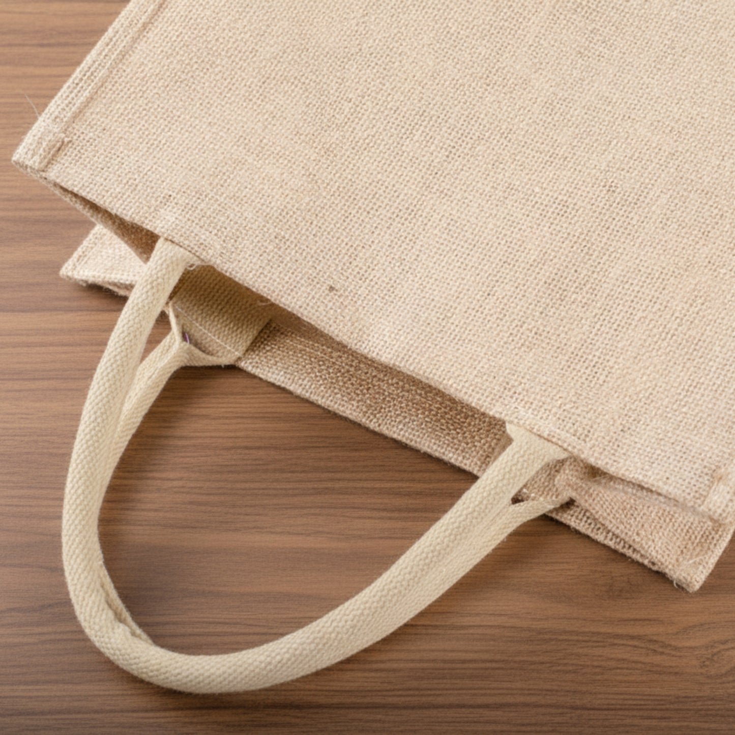 Jute Bag close up on a wooden background. Minimalist accessories inspired by natural materials and Scandinavian design, created for a beautiful and waterproof atmosphere.
