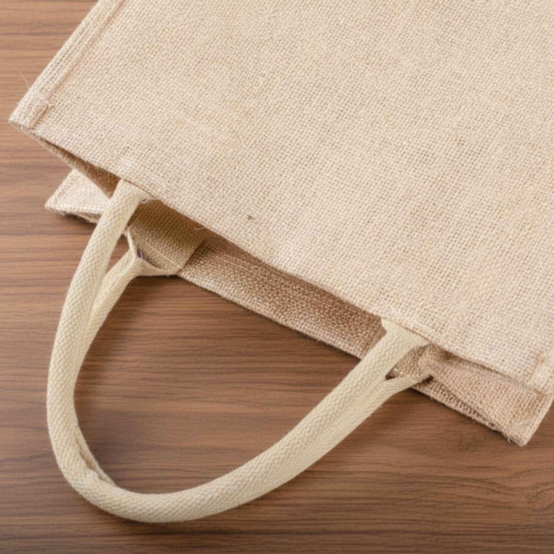Jute Bag close up on a wooden background. Minimalist accessories inspired by natural materials and Scandinavian design, created for a beautiful and waterproof atmosphere.