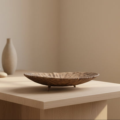 Large wooden tray with carvings on a light wooden surface with a blurred beige background. Minimalist and Scandinavian home decor with earthy ambience. 