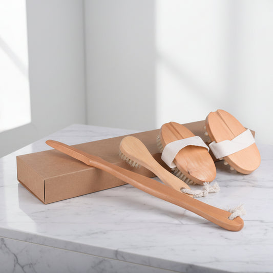 Wooden body brushes with white bands on a marble surface. Packed in a cardboard box. Earthy home decor inspired by natural textures and warm tones. Calm, cozy bathroom items with for stress relief. 