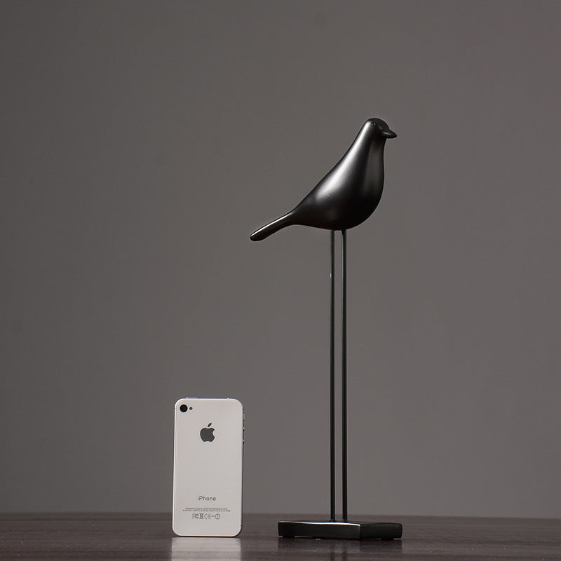 One black Nordic bird decoration made from resin, designed in a nordic and minimalist style, placed on a grey  background.