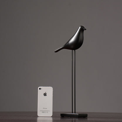 One black Nordic bird decoration made from resin, designed in a nordic and minimalist style, placed on a grey  background.