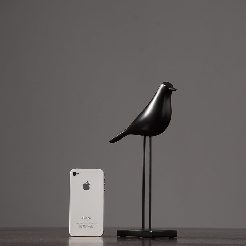 One black Nordic bird decoration made from resin, designed in a nordic and minimalist style, placed on a grey  background.