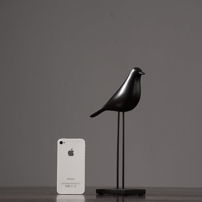 One black Nordic bird decoration made from resin, designed in a nordic and minimalist style, placed on a grey  background.