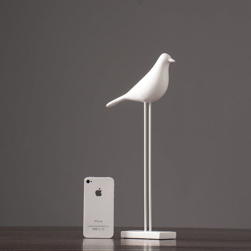 One white tall Nordic bird decoration made from resin, designed in a nordic and minimalist style, placed on a grey  background.