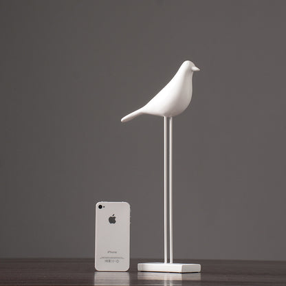 One white tall Nordic bird decoration made from resin, designed in a nordic and minimalist style, placed on a grey  background.