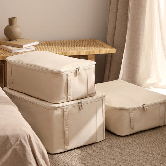 Three beige storage boxes next to a bed with an brown bench and curtain in the background. Earthy, beige and natural home decor and picture. 