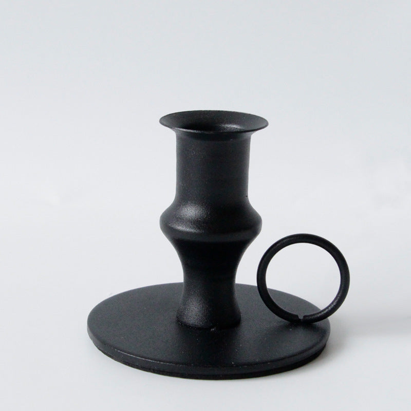 Black retro candle holder on a white background. Elegant iron black. Minimalistic home decor. 