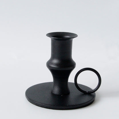 Black retro candle holder on a white background. Elegant iron black. Minimalistic home decor. 
