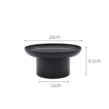 Round black storage tray with measurements on a white background. Minimalist home decor. Timeless and minimalist design. 