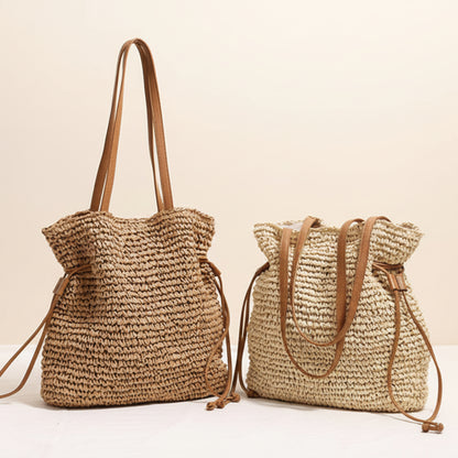 Two woven bags with brown straps on a light surface and against a light beige background. Natural chic look. Natural decor styling. Natural accessories. 