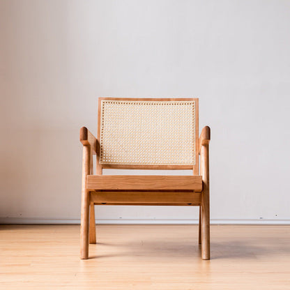 Wooden chair with woven backrest on a wooden floor. and a white wall background. Minimalist furniture design. Modern chair interior with clean lines, natural materials, and a timeless pieces that brings warmth and balance. Chair pictured from the front. 