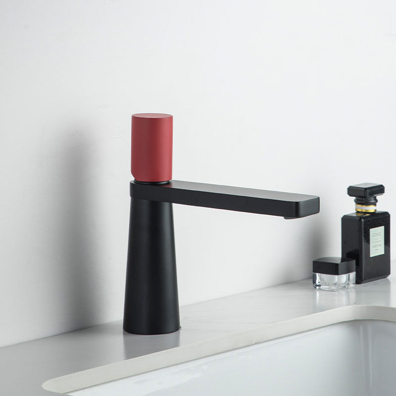 A black and red colored basin faucet with a sleek design, displayed against a white background.  Minimalist bathroom or kitchen faucet with premium copper faucet. Timeless design for warm and modern interiors.