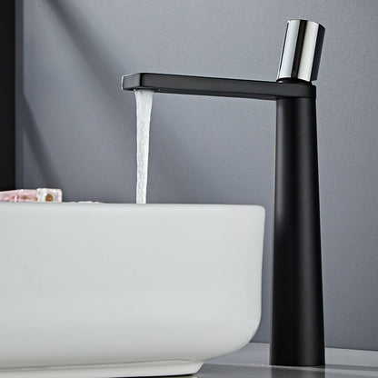 A black-colored basin faucet with a sleek design, displayed against a dark background. Minimalist bathroom or kitchen faucet with premium copper faucet. Timeless design for warm and modern interiors.