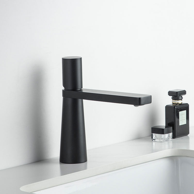 A black colored basin faucet with a sleek design, displayed against a white background.  Minimalist bathroom or kitchen faucet with premium copper faucet. Timeless design for warm and modern interiors.