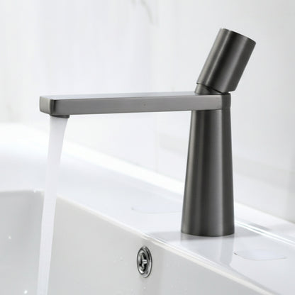 A grey colored basin faucet with a sleek design, displayed against a white background and running water.  Minimalist bathroom or kitchen faucet with premium copper faucet. Timeless design for warm and modern interiors.