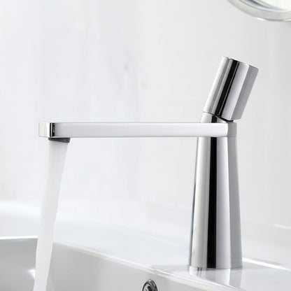 A silver colored basin faucet (small) with a sleek design, displayed against a dark background.  Minimalist bathroom or kitchen faucet with premium copper faucet. Timeless design for warm and modern interiors.