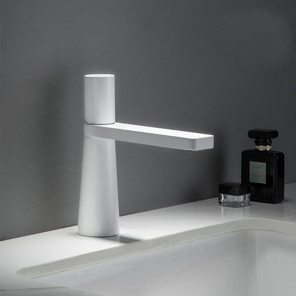 A white colored basin faucet with a sleek design, displayed against a grey background.  Minimalist bathroom or kitchen faucet with premium copper faucet. Timeless design for warm and modern interiors.