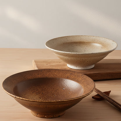 Two ceramic bowls on a wooden surface with a neutral background. Natural textures and earthy, warm tones. Timeless minimalist design.  